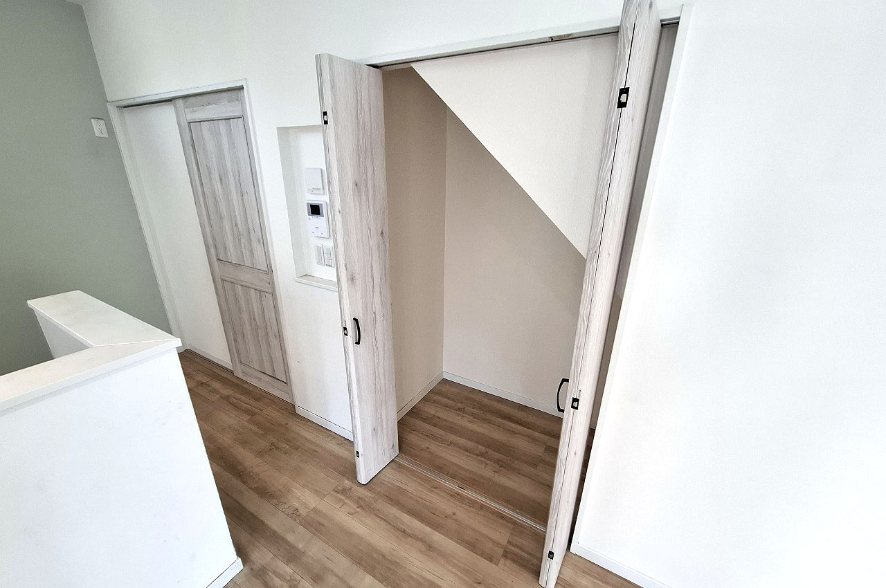 リビング内にある階段下を利用した物入。お掃除道具などの収納に便利。